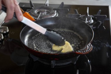 Verdeel de boter in de pan.